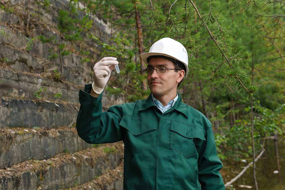 Environmental specialist analyzing sample test tube in the field